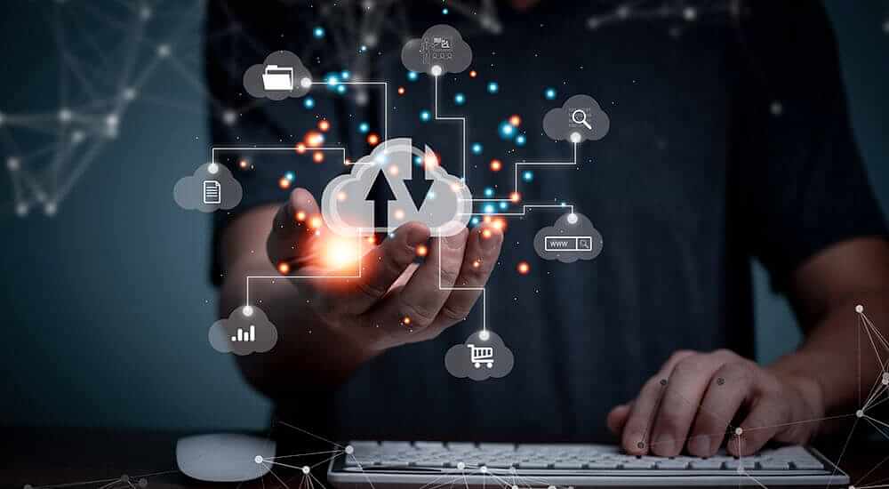 The image illustrates a professional interacting with cloud-based technology, symbolized by a glowing cloud icon and various interconnected data icons hovering above their hand. This represents Prima Consulting's Delta IFRS 17 Software, a premier SaaS solution leveraging Amazon AWS. Delta provides insurance companies with a seamless, flexible experience without the need for hardware or client-side installations. It ensures easy access, smooth processing, scalability, and reduced IT overhead, making it an optimal choice for modernizing insurance operations.