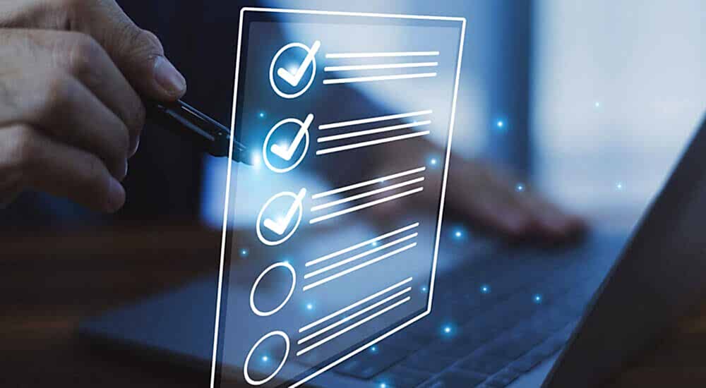 The image depicts a person using a pen to mark checkboxes on a transparent digital interface, symbolizing the concept of data validation. For Prima Consulting's Delta IFRS 17 Software, this image represents the advanced data validation system that ensures precision and reliability of all incoming data. The system includes an automatic error detection feature that quickly identifies discrepancies and provides tailored adjustment suggestions, thereby minimizing errors and enhancing the credibility of financial reporting.